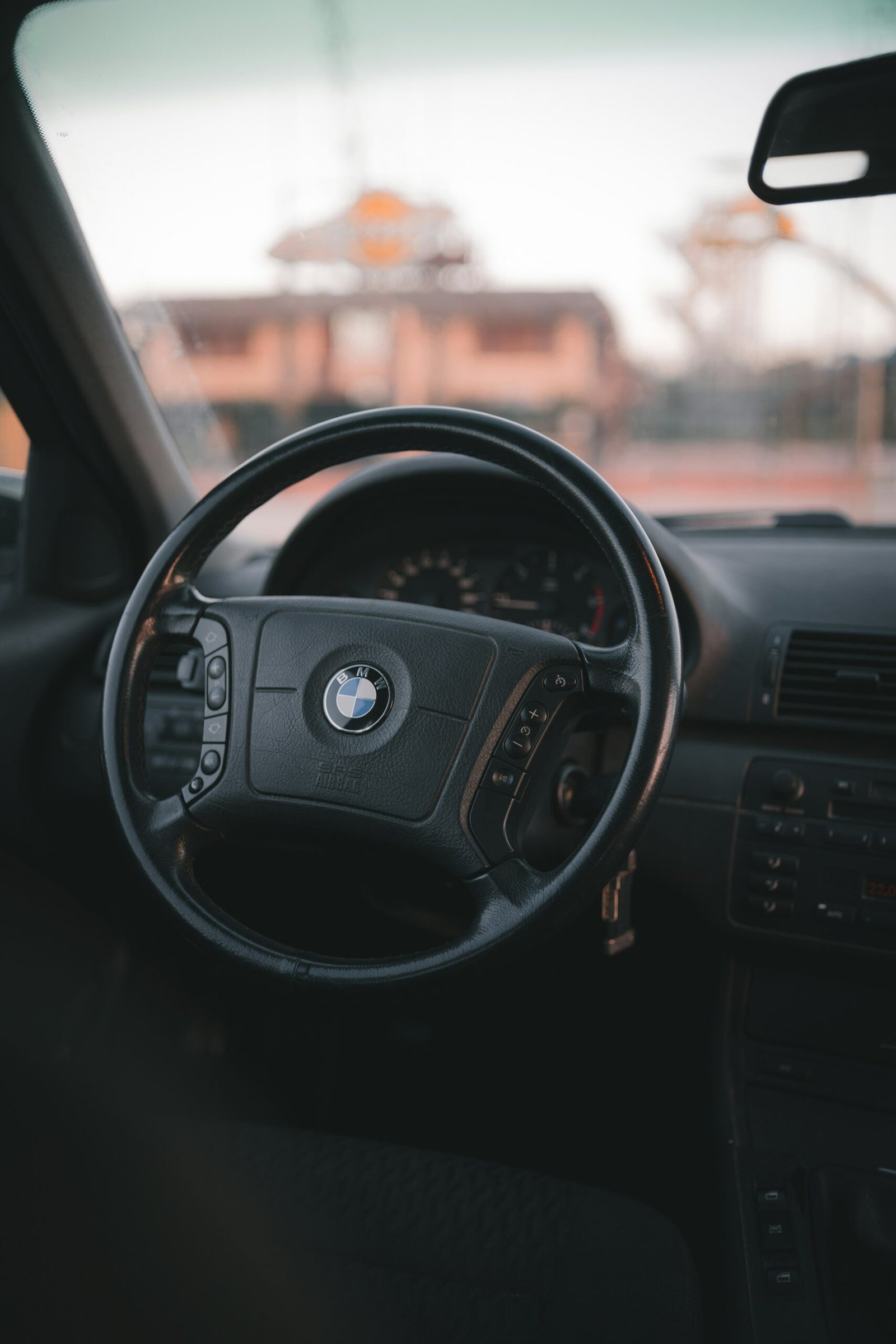 black car steering wheel during daytime